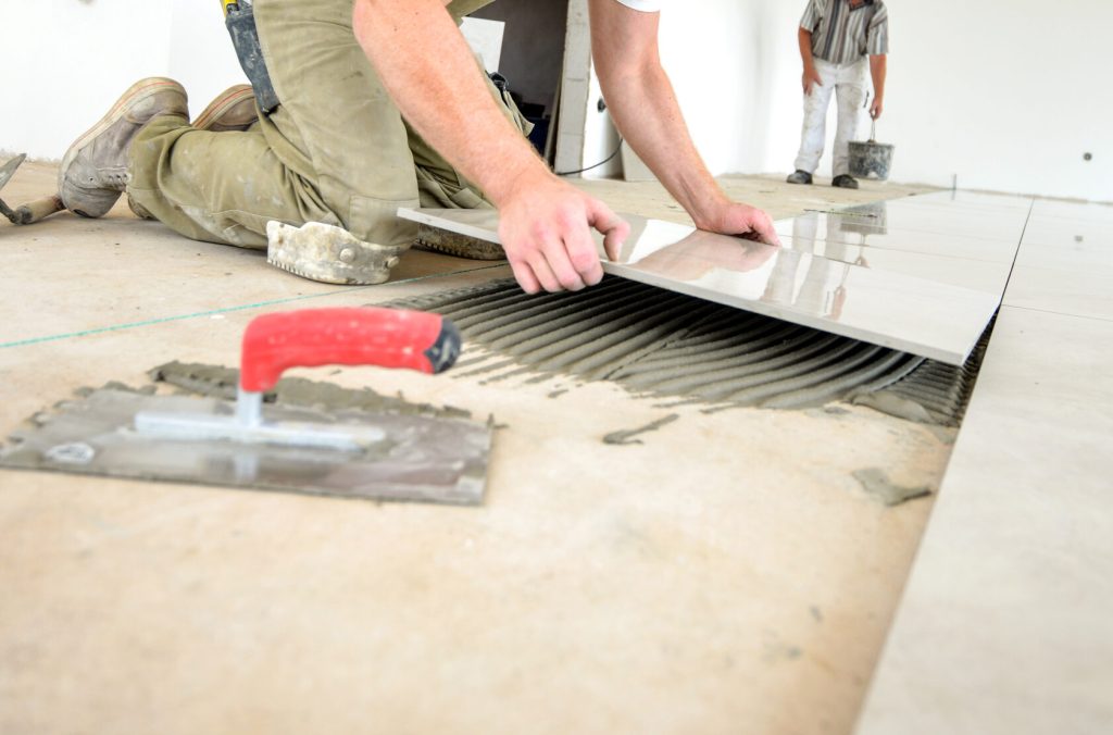 Professional skilled worker in work clothes, on the ground, selective focus, extreme little depth of field, lot of copy space, low angle view