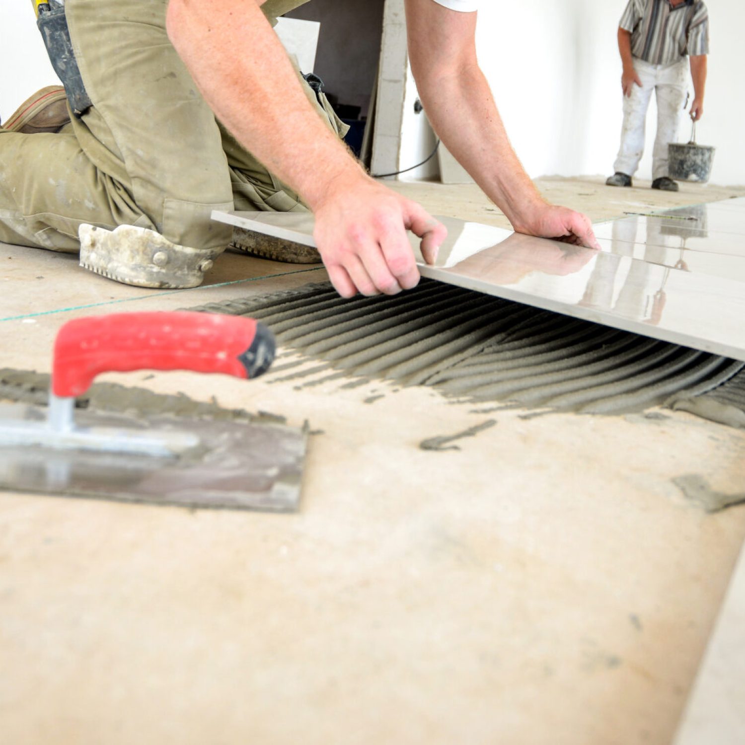 Professional skilled worker in work clothes, on the ground, selective focus, extreme little depth of field, lot of copy space, low angle view